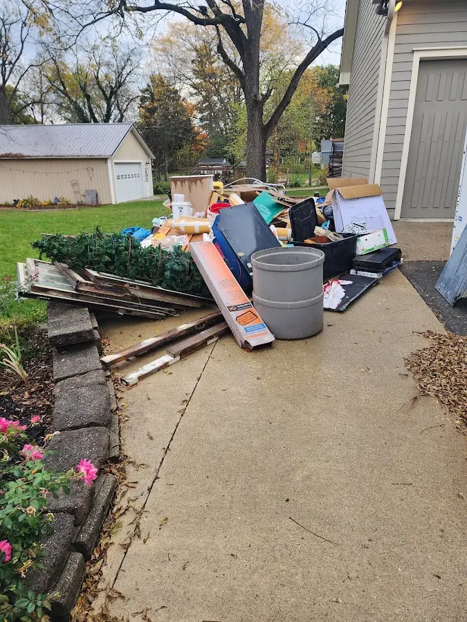 Dumpster being loaded with debris for Roofing Dumpster Rental in Stanley
